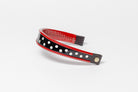 Red and white dot patent leather  browband, wide tapered design, turned edge, dark leather ends with gold button, shown angled.