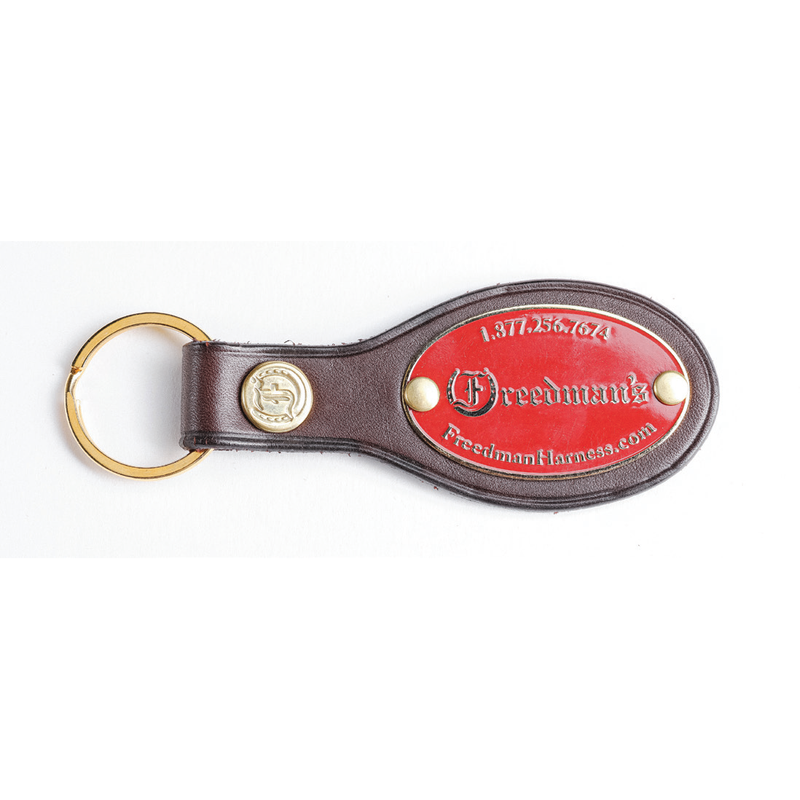  Freedman's World Cup HP Key Ring, brown leather oval with brass ring, embossed logo on leather end, red logo plate with "Freedman's" text, phone number, and website address, shown on white background.