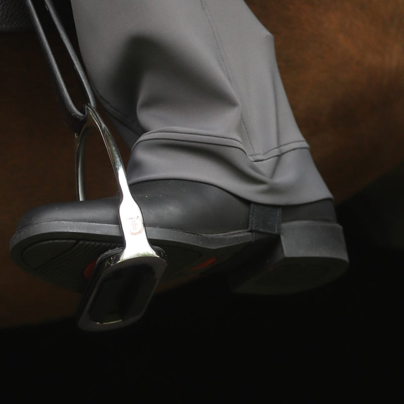 Equestrian riding boot with stirrup, illustrating how jods underpasses would be used to secure pant leg.