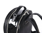 Close-up of black leather backpack, The Jaunty by Freedman's, showing zipper pulls, top handle, and patent leather accent.