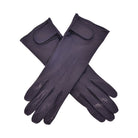 The Yorkville Show Glove, dark navy leather gloves crossed, with wrist strap and button detail, visible seam stitching, light background.