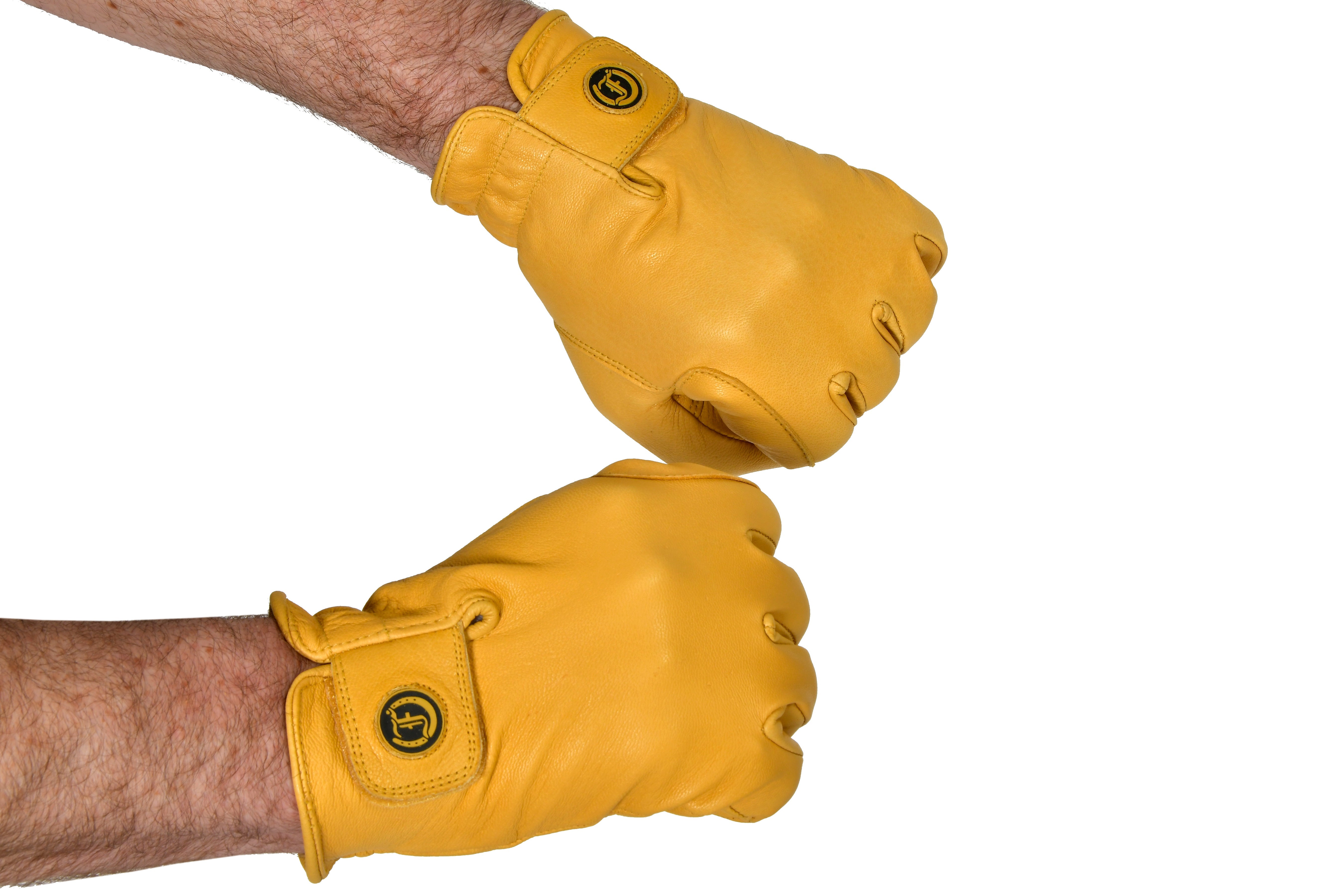 Pair of yellow leather work gloves on hands, showing soft leather and wrist strap with the Freedman's logo