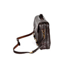 Dark Brown leather briefcase, Wagonette model, angled profile with zipper closure, shoulder strap, and handle detail.
