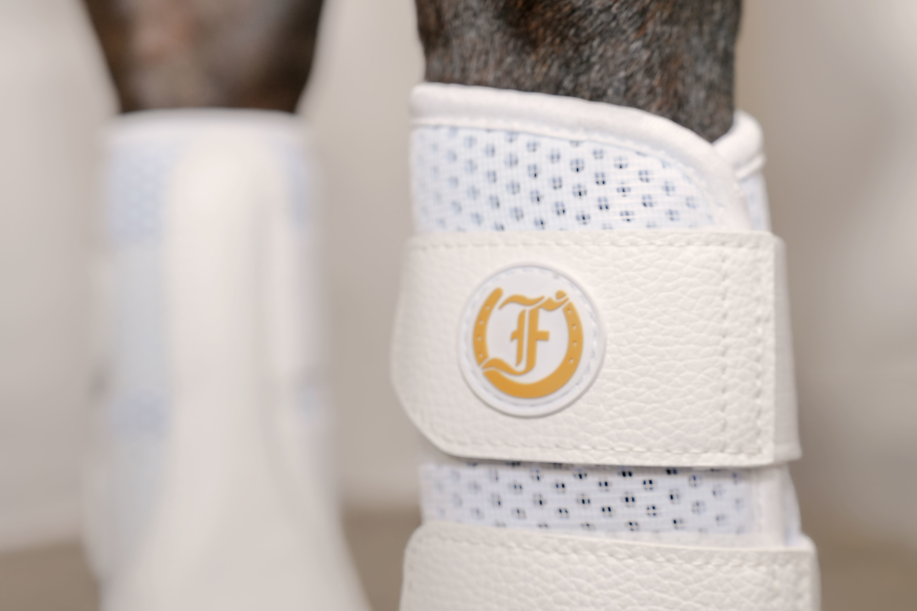 White Splint Boots on horse leg with breathable mesh lining and Freedman’s logo detail
