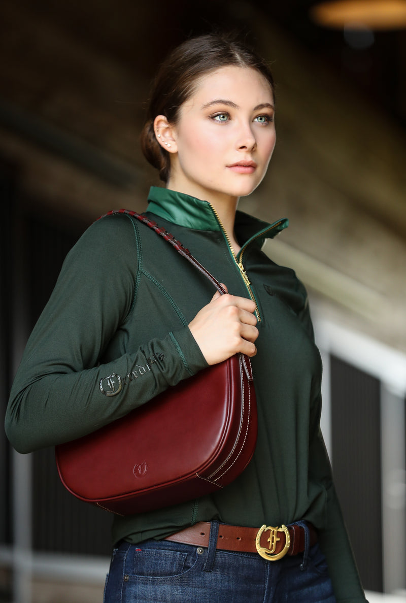 A woman carrying a black Brett Bag, showcasing its texture and design.