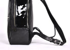 Black leather backpack, The Jaunty by Freedman's, lower view with adjustable strap, patent leather accent, and zipper detail.