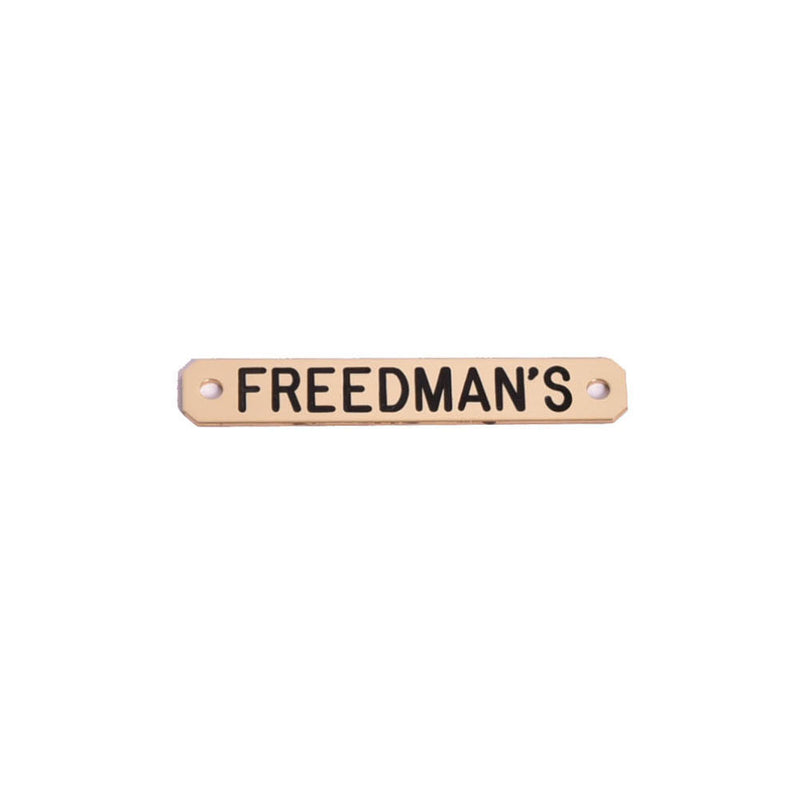 Freedman's Saddle Name Plate in brass with black lettering, displayed on a white background.


