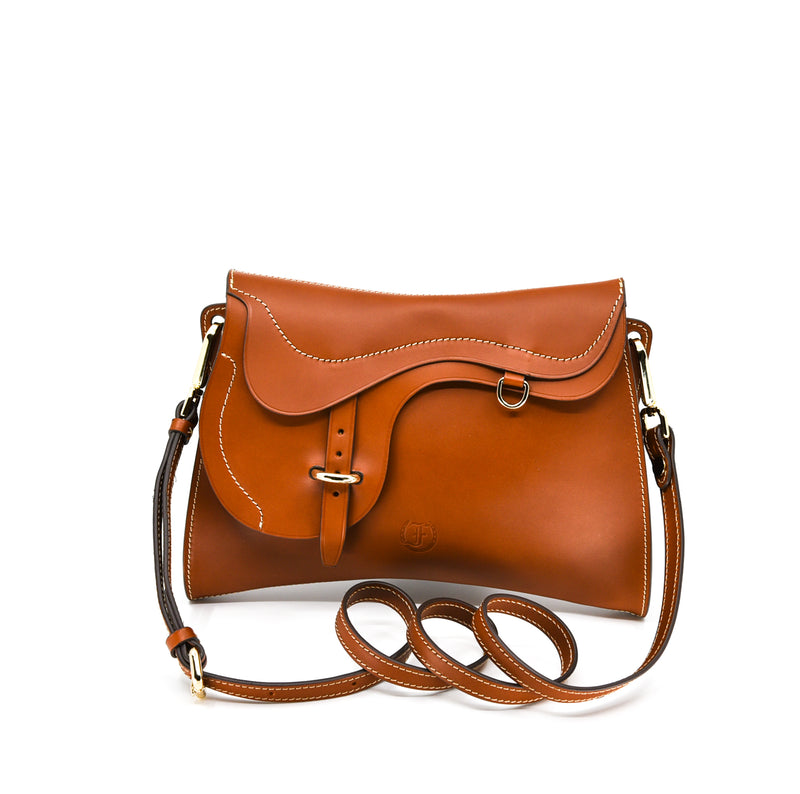 Cognac leather shoulder bag, The Trooper by Freedman's, with saddle flap detail, silver hardware, and light stitching.