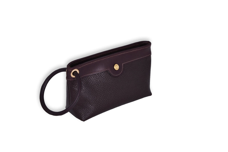 Brown leather Ring Wristlet with patent leather accent and ring detail, angled view.
