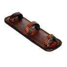 Close-up of an ACTraining tack draw tight caveson strap pad showing leather construction and loop details.